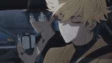 two anime characters sitting in a car with one holding a gift box