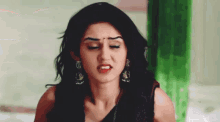 a close up of a woman making a funny face with her eyes closed