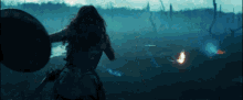 a woman holding a shield and a sword in a field