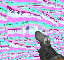 a hand holding a gun in front of a colorful background