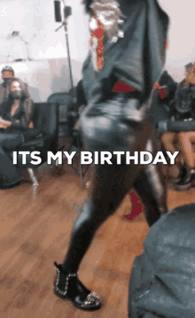 a woman is dancing in a room with the words " it 's my birthday " on the bottom