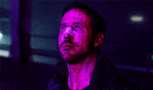 a man with blood on his face is looking up in a dark room