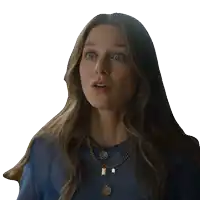 a woman with a surprised look on her face is wearing a blue shirt and gold necklaces