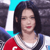 a woman wearing a baseball jersey with the letter c on it