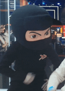 a ninja mascot is wearing a black mask and a black shirt