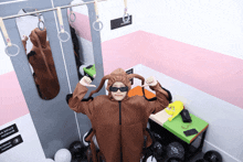 a person in a monkey costume is standing in front of a sign that says ' e ' on it