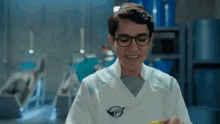 a man wearing glasses and a lab coat with a g1 logo on it