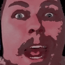 a close up of a man 's face with a beard and a surprised look on his face