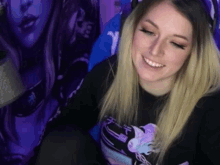 a woman wearing a black shirt with a dragon on it
