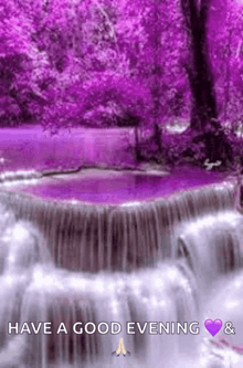 a picture of a waterfall with purple trees in the background