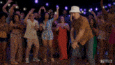 a group of people are dancing in front of a netflix sign