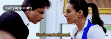 a man and a woman are talking to each other and the woman is saying you 're not allowed .