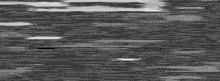 a close up of a gray and green glitch effect on a black background .