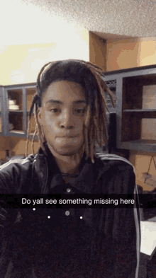 a young man with dreadlocks is taking a selfie with the caption do yall see something missing here