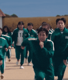 a group of people wearing green uniforms with the number 18 and 25 on their jackets