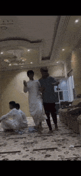 a group of men are dancing in a room