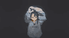 a girl in a hoodie with the word senpai on it is standing in front of a whale .