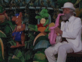 a man in a white suit is playing a pink saxophone in front of a jungle scene