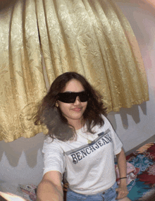 a girl wearing sunglasses and a bench jeans shirt