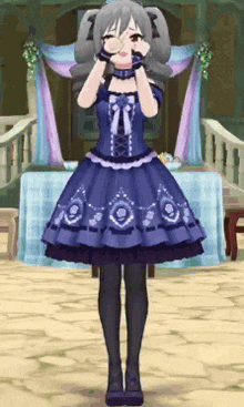 a girl in a blue dress is standing in front of a table with flowers on it