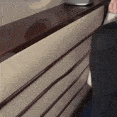 a person standing in front of a counter that has a sticker on it that says no smoking
