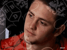 a close up of a man 's face with the letters rb and d visible