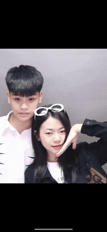a boy and a girl are posing for a picture together