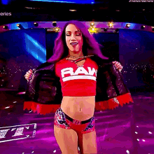 a woman with purple hair is wearing a raw top