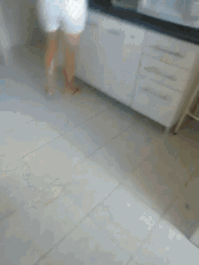 a blurry picture of a person standing on a gray floor