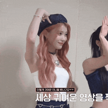 a woman with pink hair is wearing a white tank top