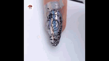 a close up of a woman 's nails with a unicorn design on them .