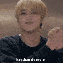a close up of a man with the words haechan de more on the bottom