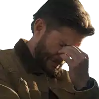 a man with a beard is covering his face with his hands