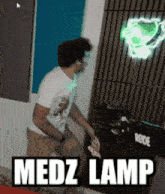 a man is dancing in front of a medz lamp sign
