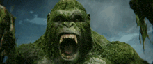 a close up of a green gorilla with its mouth wide open