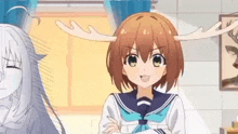 a girl with antlers on her head is standing in a room next to another girl .