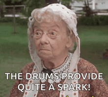 an elderly woman wearing a white hat says the drums provide quite a spark !