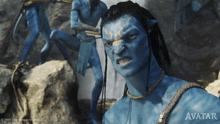 a movie poster for avatar shows a man with a blue face