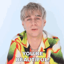 a man in a colorful shirt is saying you 're beautiful