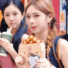 a woman is holding a bag of food that has a circle on it