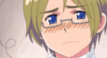 a close up of a boy wearing glasses and making a face .