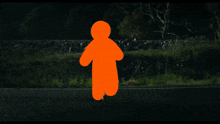 a car is driving down a road at night with a silhouette of a person in the background