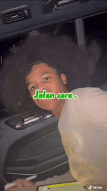 a young man sitting in a car with the words jalan core written on the bottom
