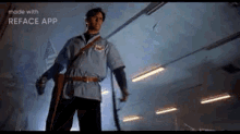 a man in a blue shirt and black pants is standing in a dark room holding a sword .