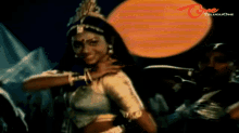a woman with a crown on her head is dancing in front of a telugu one logo