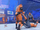 a wrestling match is underway with a sign that says cena