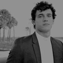 a black and white photo of a man in a suit and white shirt