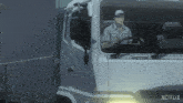 a man is driving a white truck that says netflix on the side