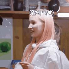 a woman with pink hair has a heart on her head in korean