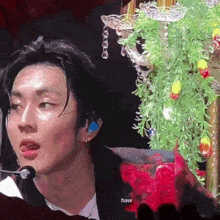 a man in a suit is sitting in front of a christmas tree .